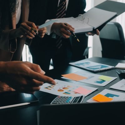 Business team collaboration discussing working analyzing with financial data and marketing growth report graph in team, presentation and brainstorming to strategy planning making profit of company.