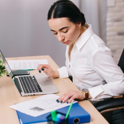 Young woman works with documents in office